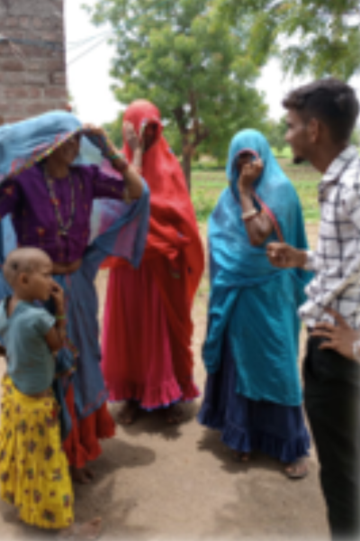 Siyaram in conversation with community women and a child in a Central Indian village